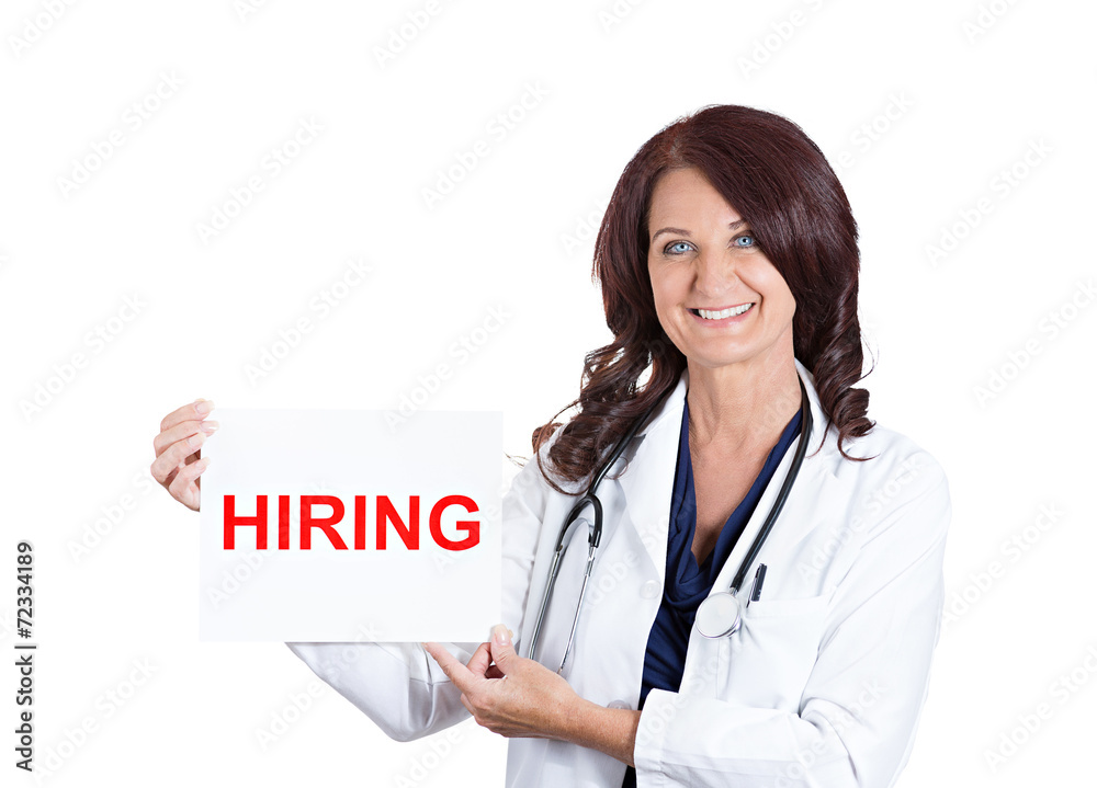 female medical doctor or nurse showing hiring sign on white female medical doctor or nurse showing hiring sign on white
