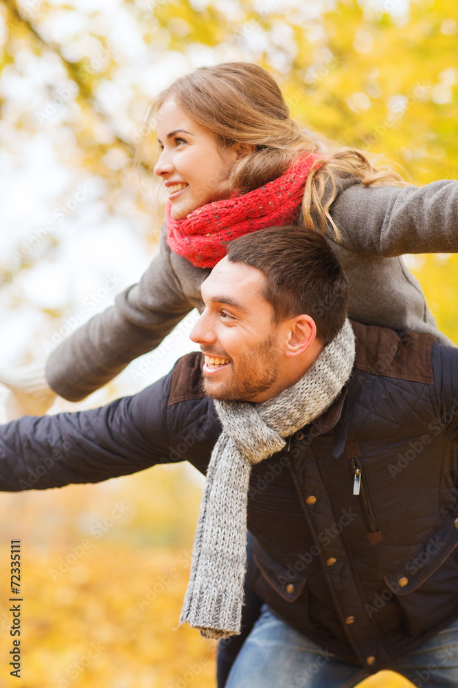 smiling couple having fun in autumn park smiling couple having fun in autumn park