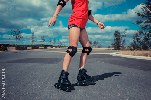 Young woman rollerblading on sunny day
