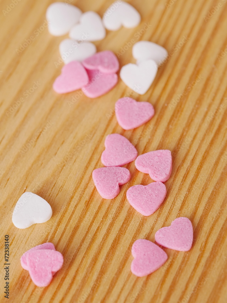 Fototapeta premium candy hearts wood background