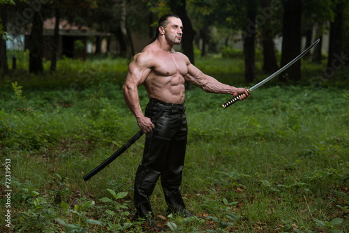 Portrait Of A Muscular Ancient Warrior With Sword