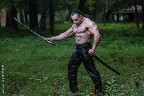 Portrait Of A Muscular Ancient Warrior With Sword