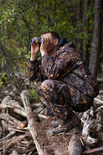 man with binoculars out hunting