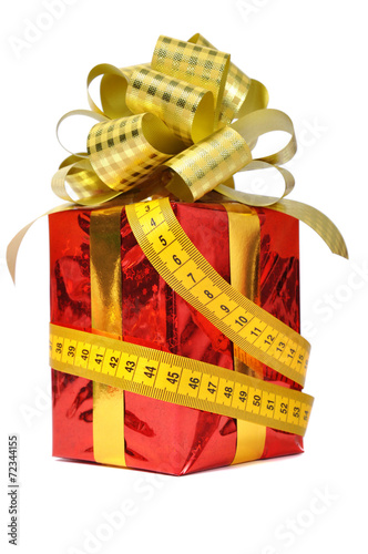 Red gift and measure tape over white