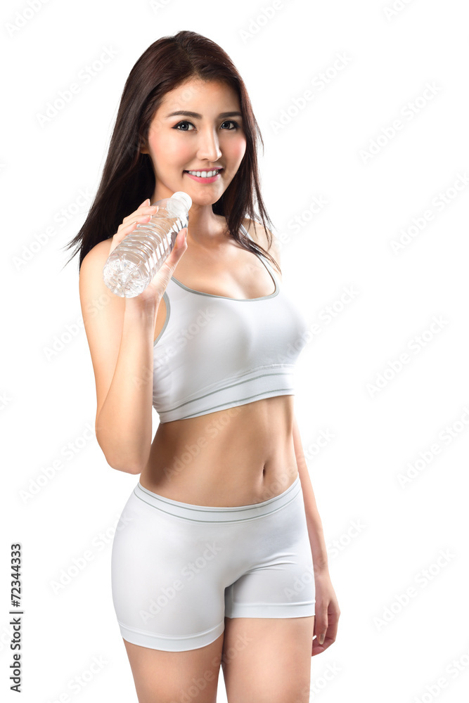 Excited young asian woman showing a bottle of water after doing Excited young asian woman showing a bottle of water after doing