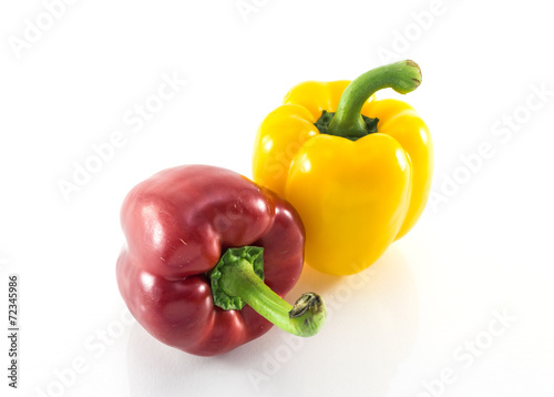 Red and yellow peppers solated on white