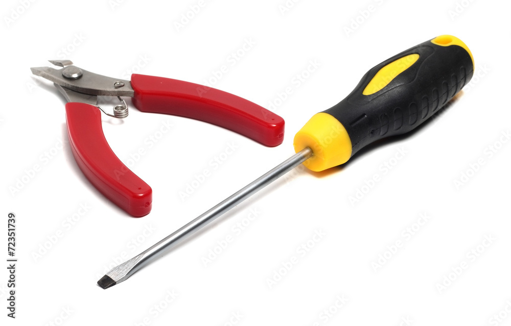 small pliers and a flat screwdriver long on a white background small pliers and a flat screwdriver long on a white background