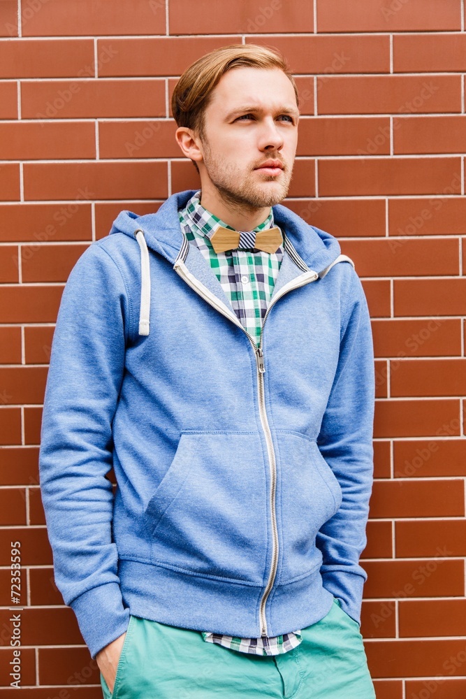 Portrait of young fashion man in casual wear and wooden bowtie Portrait of young fashion man in casual wear and wooden bowtie