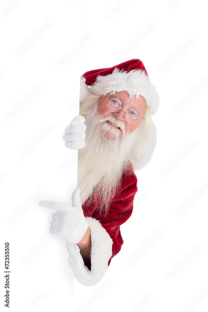 Naklejka premium Santa looks out behind a wall