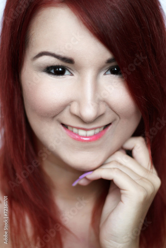 Beautiful smiling redhead young woman with bright make up portra
