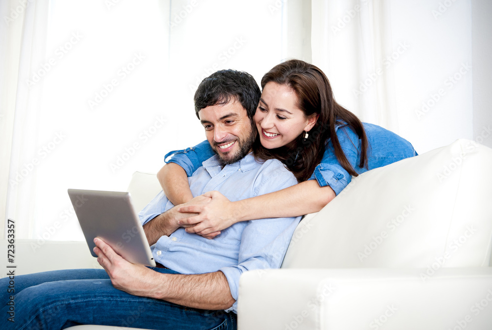 couple on couch using digital tablet computer online internet couple on couch using digital tablet computer online internet
