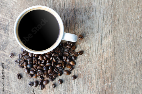 Fototapeta Naklejka Na Ścianę i Meble -  Black coffee with beans in on grained wood