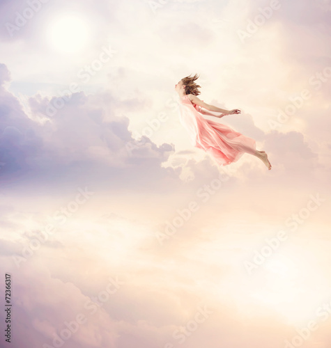 Girl in a pink dress flying in the sky