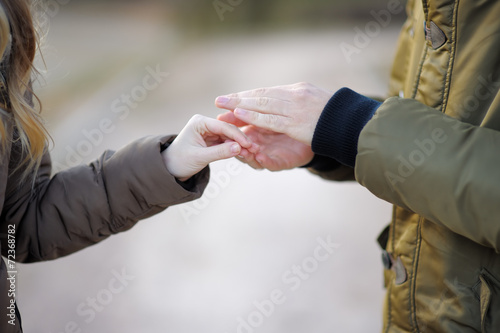 Man holding woman's hand