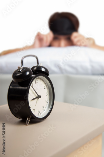 Allarm clock with sleepy Asian girl