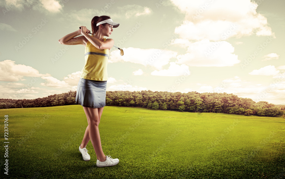 Active female player preparing for hitting golf ball.