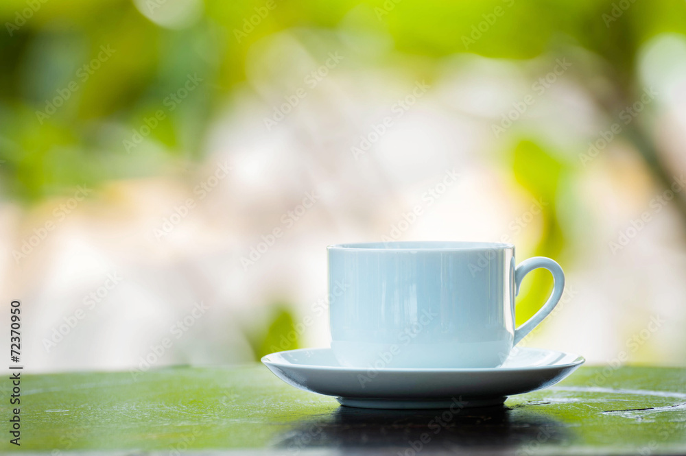 coffee cup on wood over nature background coffee cup on wood over nature background