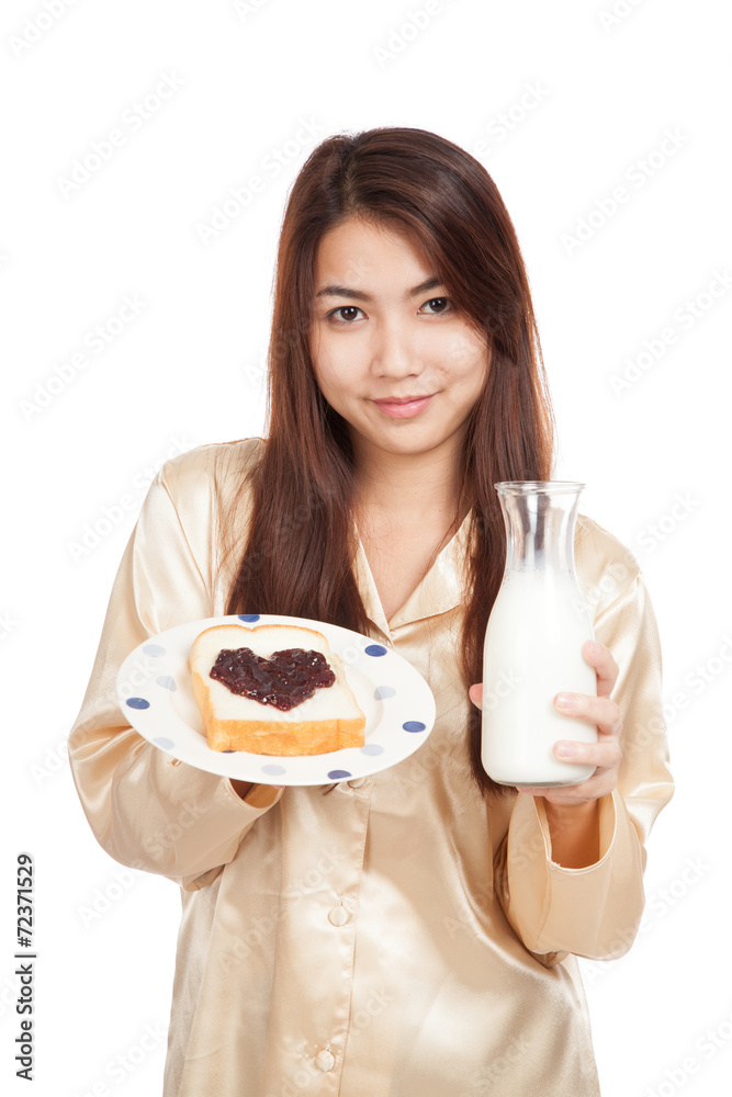 Asian woman with milk bottle , bread and heart shape berry jam Asian woman with milk bottle , bread and heart shape berry jam