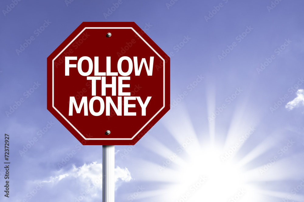 Follow the Money written on red road sign Follow the Money written on red road sign