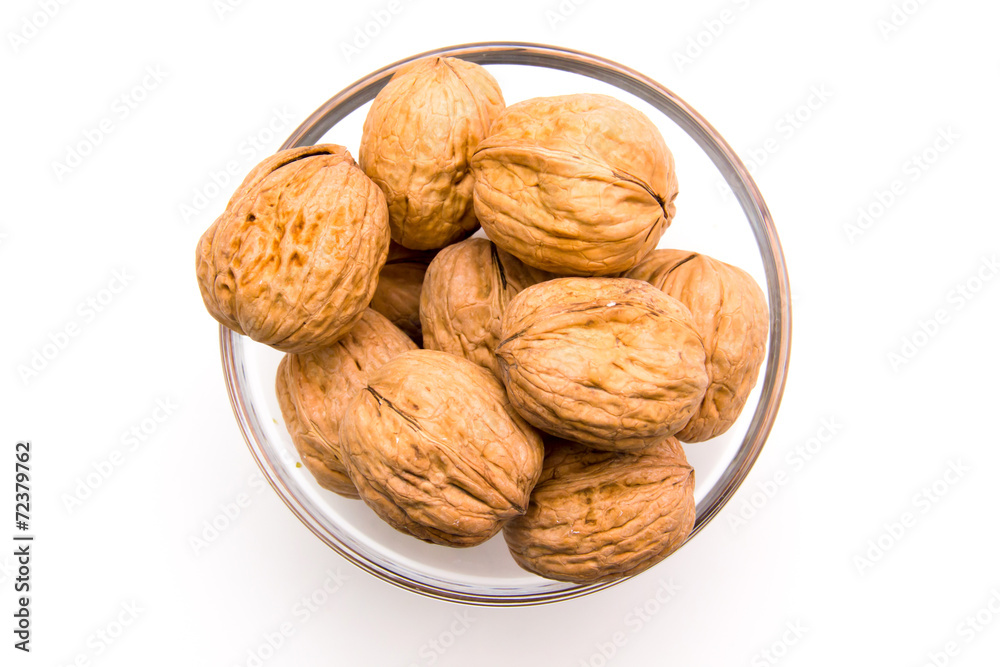 Nuts on bowl on white background seen from above Nuts on bowl on white background seen from above