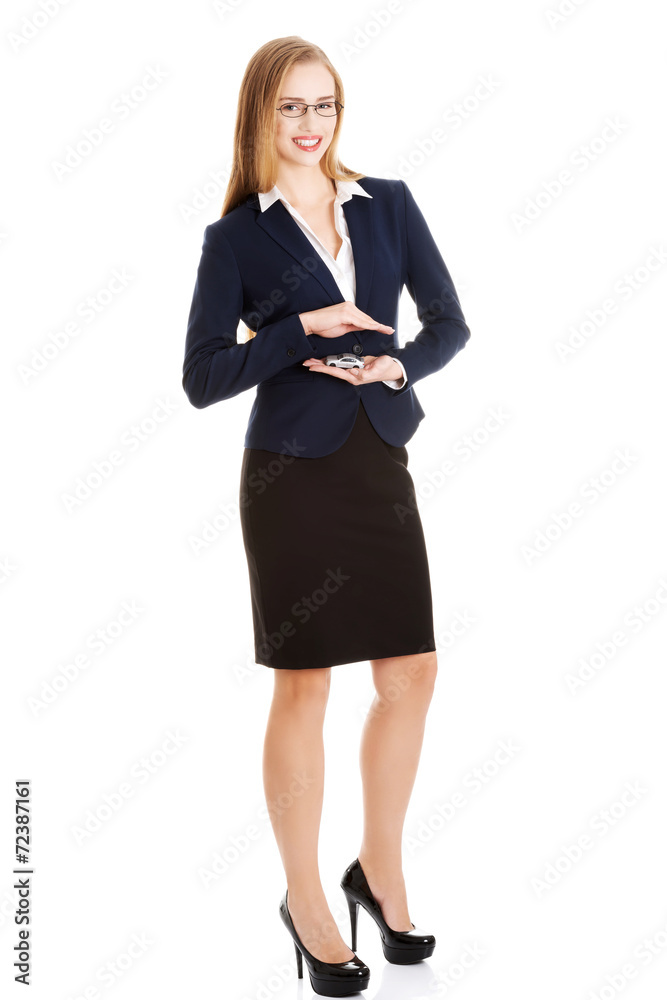 Businesswoman holding a model of car Businesswoman holding a model of car