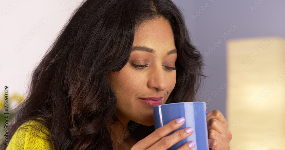 Hispanic woman enjoying her cup of coffee Hispanic woman enjoying her cup of coffee
