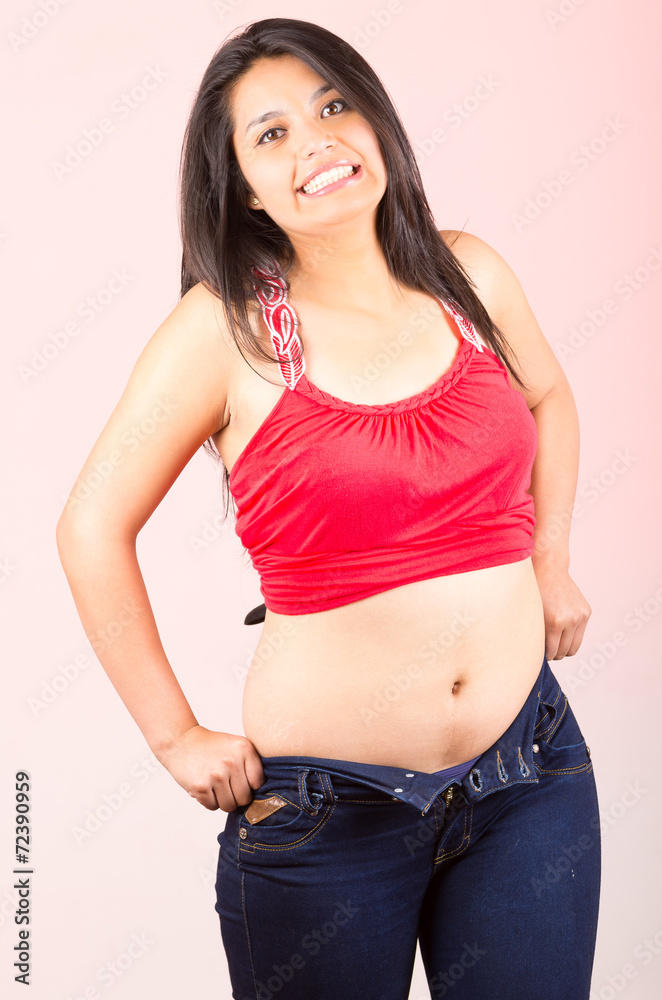 young girl struggling trying to fit into tight jeans Stock Photo | Adobe  Stock