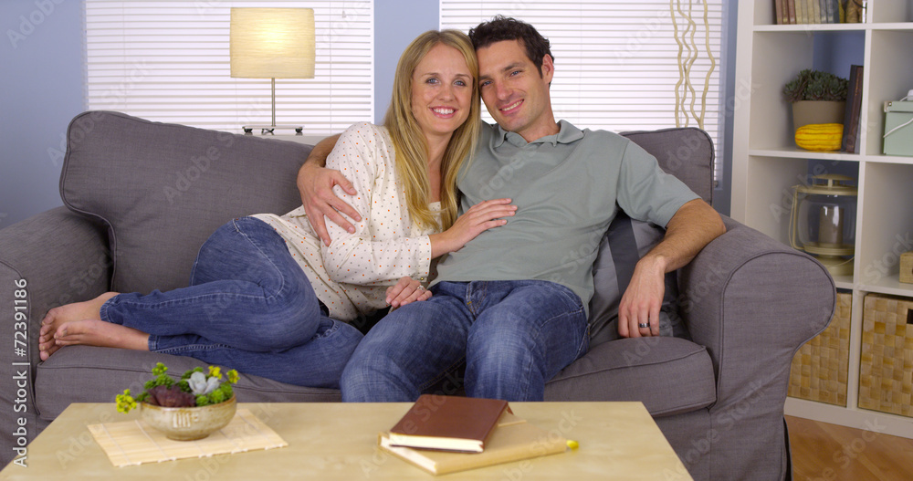 Sweet couple cuddling on couch Sweet couple cuddling on couch