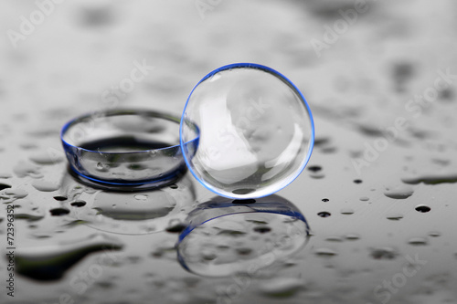 фотографія Contact lenses with water drops on bright background