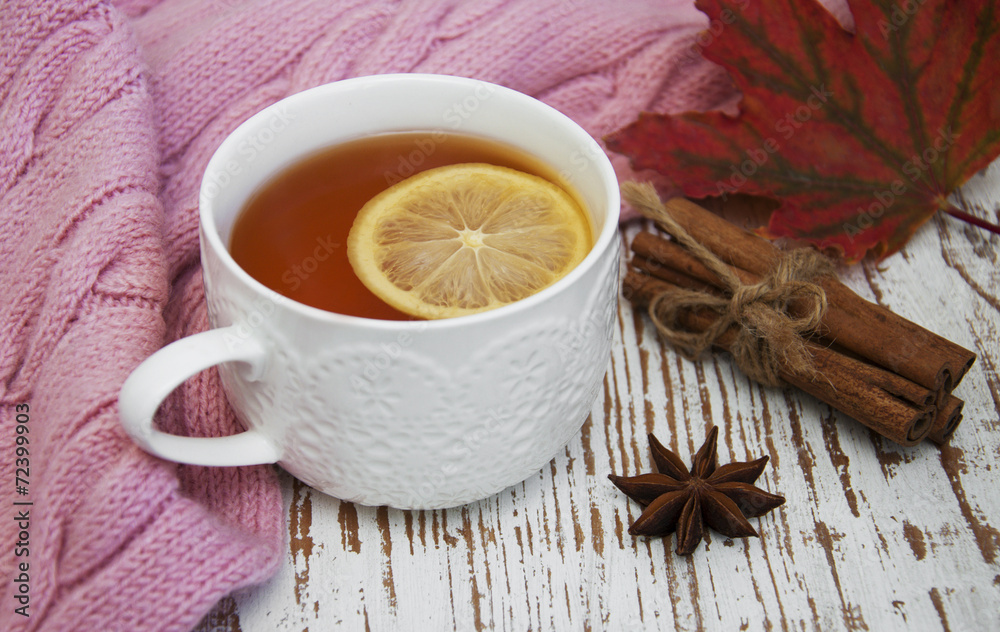 Cup of hot tea with lemon and scarf Cup of hot tea with lemon and scarf