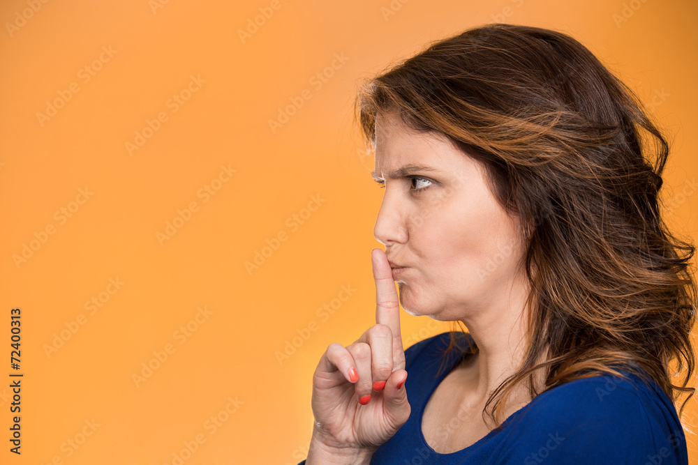 Quiet side profile woman asking to keep secret finger on lips Quiet side profile woman asking to keep secret finger on lips
