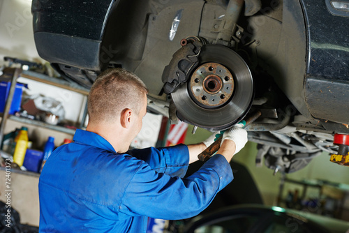 auto mechanic at car suspension repairing