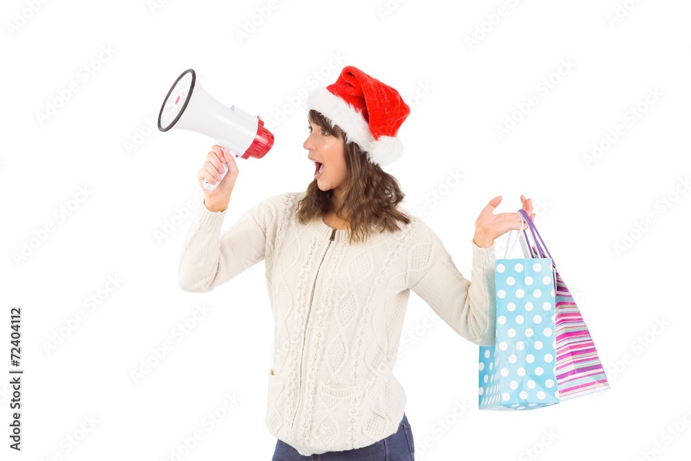 Festive brunette holding megaphone and bags Festive brunette holding megaphone and bags