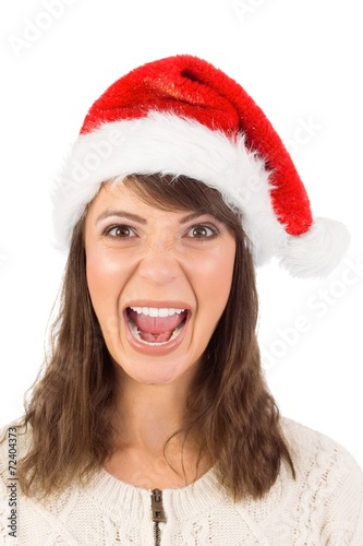 Young woman in santa hat yelling