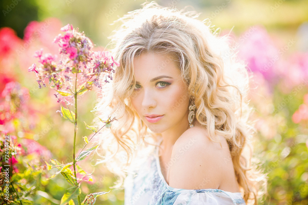 beautiful young girl in a garden of flowers beautiful young girl in a garden of flowers