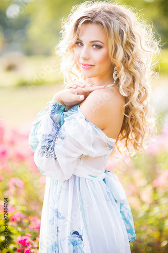 beautiful young girl in a garden of flowers