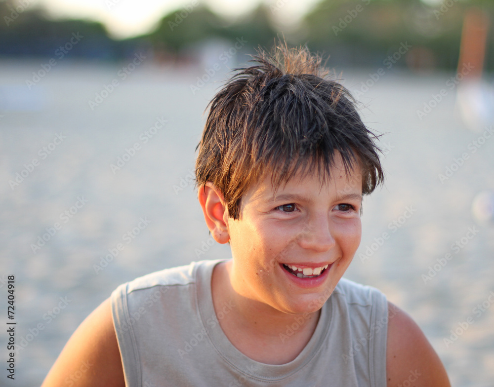 boy smiling in the summer at the beach