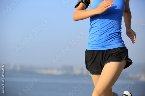 Fototapeta Naklejka Na Ścianę i Meble -  woman runner athlete running at seaside