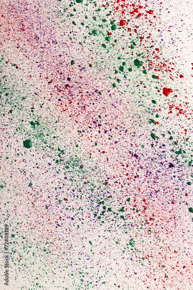 Multicolored ink stains on white paper