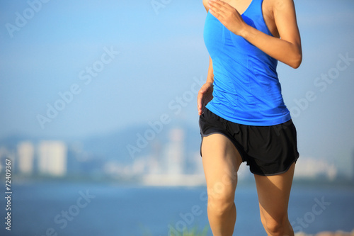 woman runner athlete running at seaside