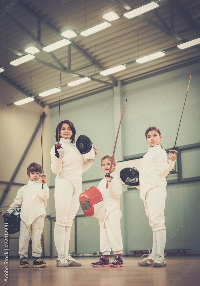 Obraz premium Children fencers and their trainer