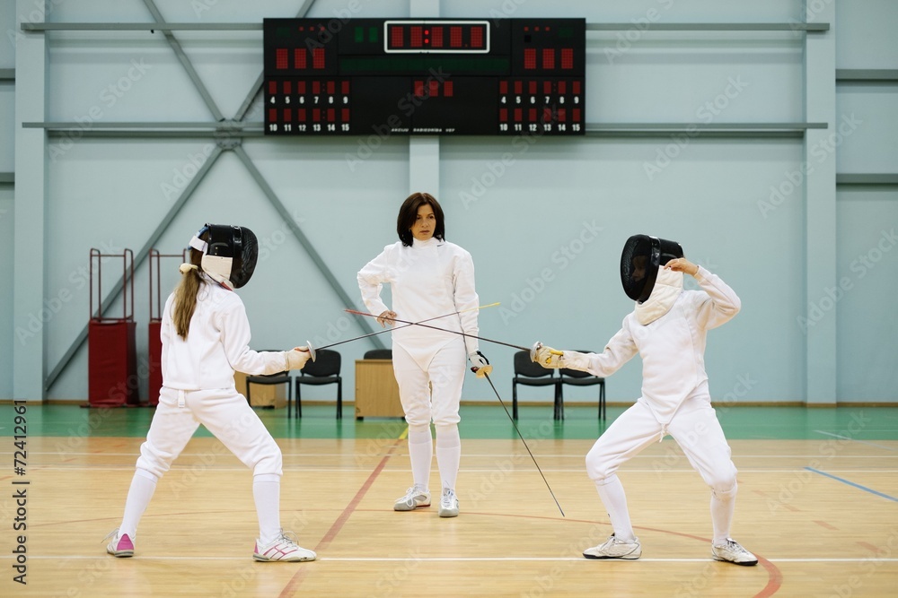 Children fencers and their  trainer