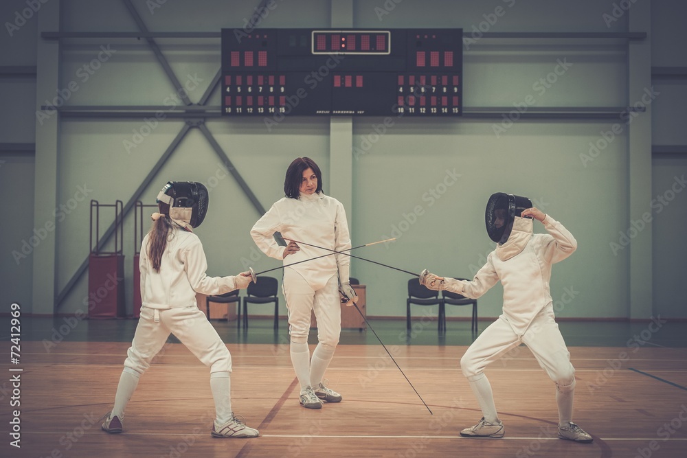 Children fencers and their trainer Children fencers and their trainer