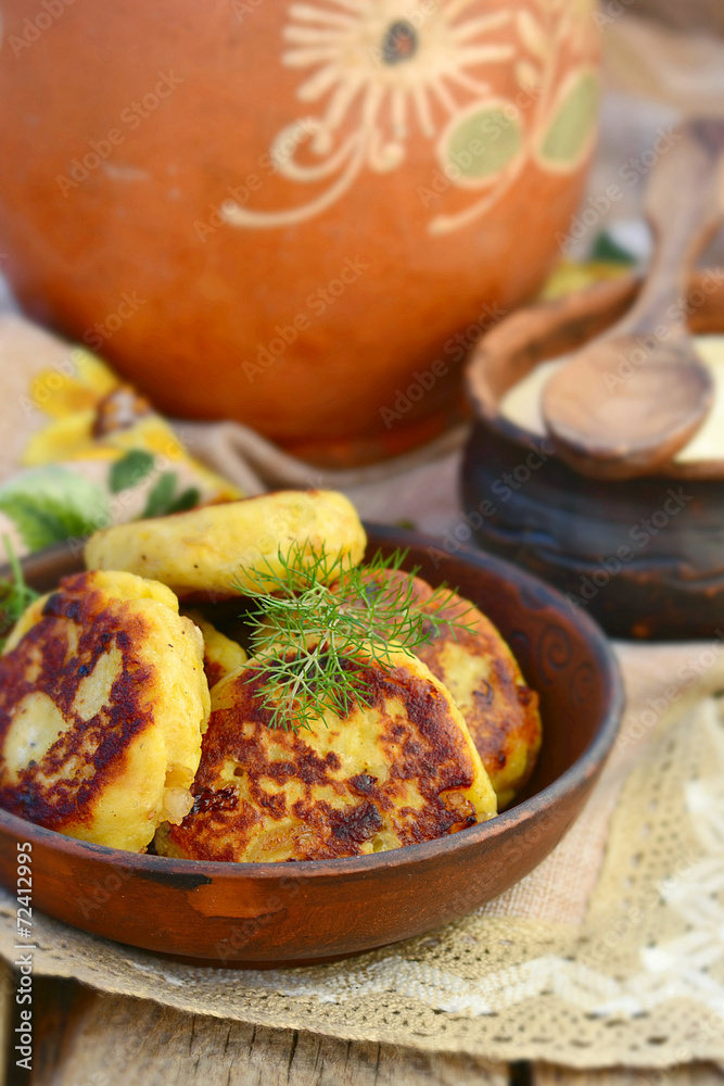 potato patties with fried bacon and onions. potato patties with fried bacon and onions.