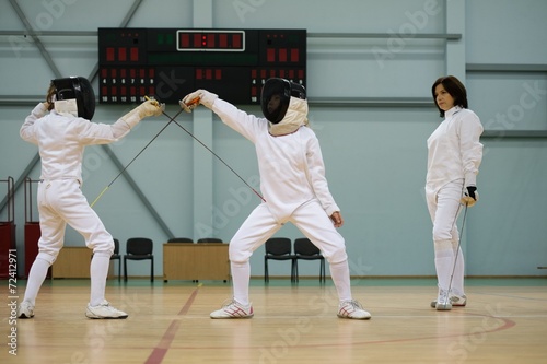 Children fencers and their trainer