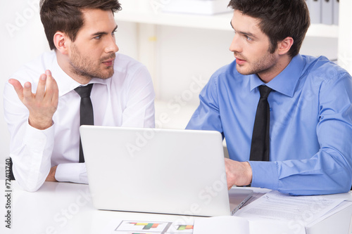 two businessmen having discussion in office.