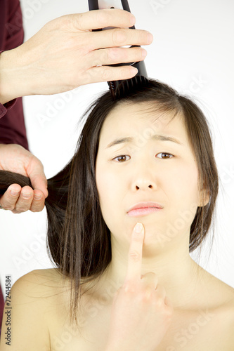 Asian woman not sure to shave her long hair