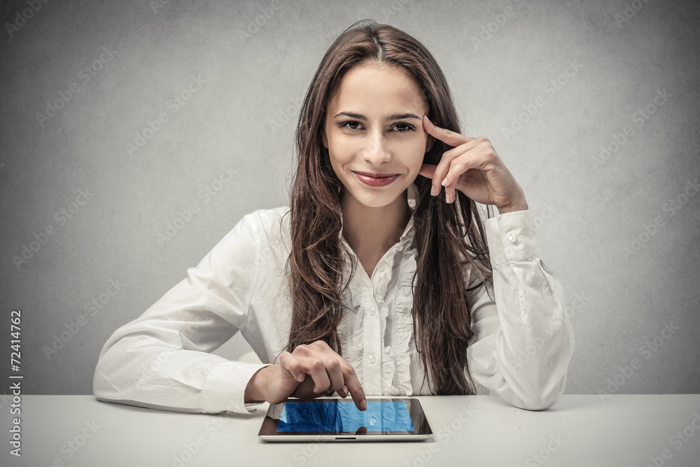 Smiling businesswoman using a tablet