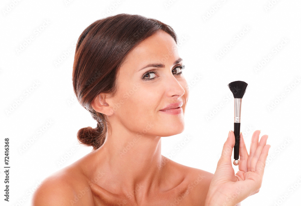 Young woman with make up brush showing her purity Young woman with make up brush showing her purity