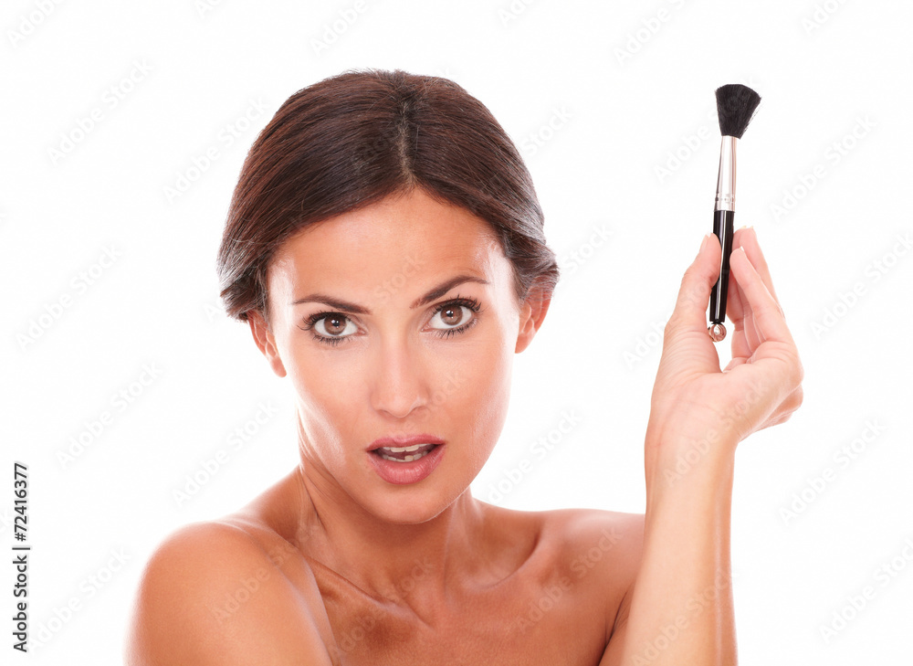 Woman with make up brush for pampering her face